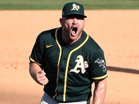 Oakland Athletics relief pitcher Liam Hendriks (16) celebrates after the Athletics defeated the Houston Astros at Dodger Stadium.