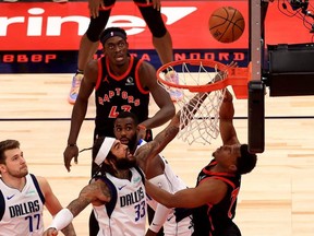 Raptors’ Kyle Lowry (right) shoots over Dallas’ Willie Cauley-Stein at Amalie Arena in Tampa last night. The Raptors won 116-93.  Mike Ehrmann/Getty Images