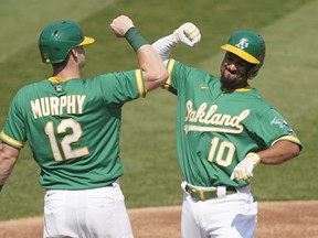 Marcus Semien, right, and Sean Murphy of the Oakland Athletics celebrates after Semien hit a two-run home run against the Chicago White Sox during the second inning of Game 2 of the American League Wild Card Round at RingCentral Coliseum on Sept. 30, 2020 in Oakland, Calif.