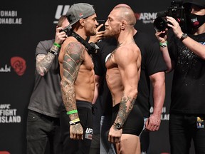In this handout image provided by the UFC, Dustin Poirier and Conor McGregor face off during the UFC 257 weigh-ins at Etihad Arena on UFC Fight Island on January 22, 2021 in Abu Dhabi, United Arab Emirates.