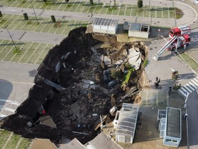 A aerial view shows a sinkhole in the Ospedale del Mare hospital car park, located in the outskirts of the city of Naples, after the ground collapsed early on Jan. 8, 2021.