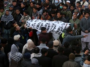 People and family members carry a body of their relative, who was a coal miner and was killed along with other coworkers from Pakistan's minority Shi'ite Hazara community in Quetta, Pakistan January 3, 2021.