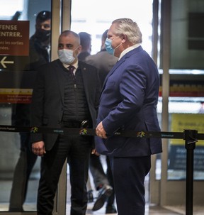 Ontario Premier Doug Ford leaves the Terminal 1 International Arrivals area of Toronto Pearson International Airport on Tuesday, Jan. 26, 2021.