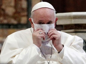 Pope Francis, wearing a face mask, attends an inter-religious prayer in the Basilica of Santa Maria in Aracoeli in Rome Oct. 20, 2020.