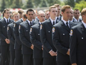 Firefighter graduates line up to enter the Toronto Fire Services graduation program held at the Toronto Fire Academy in Toronto, Ont.  on Thursday, July 31, 2014.