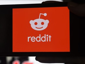 This photo illustration shows the logo of Reddit on a mobile phone in Arlington, Va. on Jan. 29, 2021.