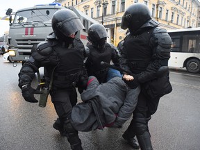 Police detain a man during a rally in support of jailed opposition leader Alexei Navalny in St. Petersburg on January 23, 2021.