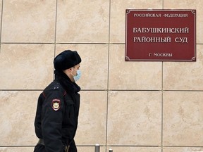 A police officer patrols outside the Babushkinsky district court in Moscow on Wednesday, Jan. 20, 2021.