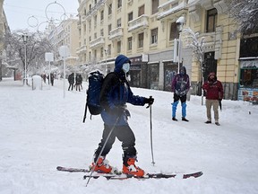 A woman skis amid a heavy snowfall in Madrid on January 9, 2021.