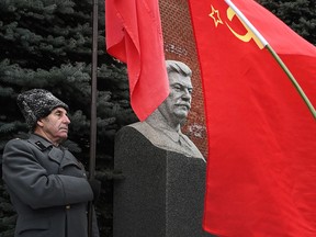 Russian Communist party supporters lay flowers to the tomb of late Soviet leader Joseph Stalin during a memorial ceremony to mark the 141st anniversary of his birth at Red Square in Moscow on December 21, 2020.