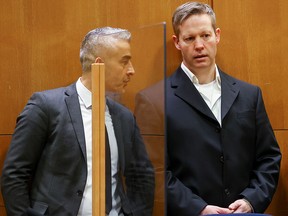 Main defendant Stephan Ernst (right) speaks his lawyer, Mustafa Kaplan, in the courtroom as they wait for the verdict in Frankfurt am Main, Germany, January 28, 2021.