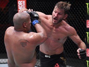 In this handout image provided by UFC, Stipe Miocic (right) punches Daniel Cormier in their heavyweight championship bout during UFC 252 at UFC APEX on August 15, 2020 in Las Vegas.