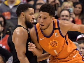 Phoenix Suns guard Devin Booker (right) drives to the basket against Toronto Raptors guard Fred VanVleet at Scotiabank Arena on Feb. 21, 2020.