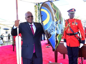 Tanzania's re-elected President John Pombe Magufuli holds a spear and shield from the elders after he was sworn-in for the second term at the Jamhuri stadium in Dodoma, Tanzania November 5, 2020.