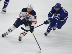 Toronto Maple Leafs John Tavares chases down Edmonton Oilers Connor McDavid in Toronto on Jan. 22, 2021.