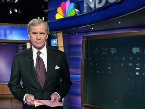 Tom Brokaw poses on the set of the "NBC Nightly News" at an NBC studio in New York, Feb. 1, 2001.