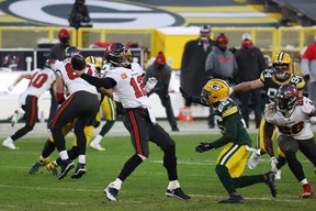 Quarterback Tom Brady of the Tampa Bay Buccaneers throws an interception under pressure from Darnell Savage of the Green Bay Packers in the fourth quarter during the NFC Championship game at Lambeau Field on Jan. 24, 2021 in Green Bay, Wisc. Dylan Buell/Getty Images