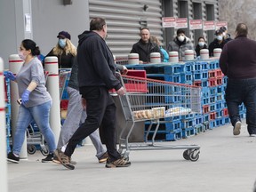 Costco customers line up for products in East York on March 26, 2020.
