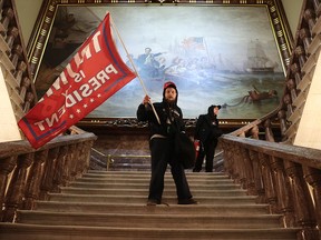 A protester holds a Trump flag inside the U.S. Capitol Building near the Senate Chamber on January 6, 2021 in Washington.