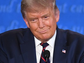 In this file photo President Donald Trump smiles during the first presidential debate at Case Western Reserve University and Cleveland Clinic in Cleveland, Ohio, on September 29, 2020.