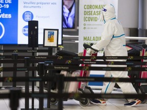A passenger is covered head to toe at the International Arrivals area at Terminal 3 at Toronto Pearson International Airport on Tuesday, January 26, 2021.
