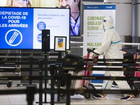 A passenger is covered head to toe at the International Arrivals area at Terminal 3 at Toronto Pearson International Airport on Tuesday January 26, 2021. Ernest Doroszuk/Toronto Sun/Postmedia