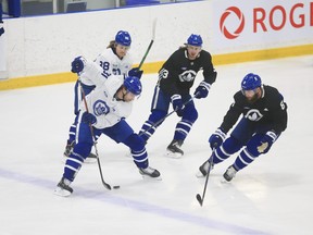 Toronto Maple Leafs John Tavares C (91) cuts along the blue line and drops a pass through his legs to William Nylander RW (88) at practice in Toronto on Tuesday January 12, 2021. Jack Boland/Toronto Sun/Postmedia Network