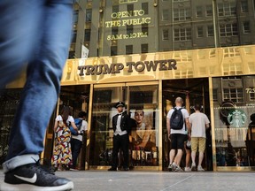 People walk by Trump Tower on Fifth Avenue in Manhattan in New York City, Aug. 24, 2018.