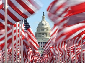 The Capitol building is seen surrounded by American flags on the National Mall in Washington, D.C., Tuesday, Jan. 19, 2021.