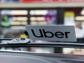 An Uber sticker is seen on vehicle in Lafayette, La., Feb. 16, 2020.
