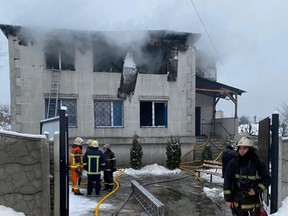Rescuers work at the scene of a fire at a nursing home in Kharkiv, Ukraine, Thursday, Jan. 21, 2021.
