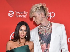 In this handout image courtesy of ABC rapper Machine Gun Kelly and actress Megan Fox arrive for the 2020 American Music Awards at the Microsoft theatre on November 22, 2020 in Los Angeles.