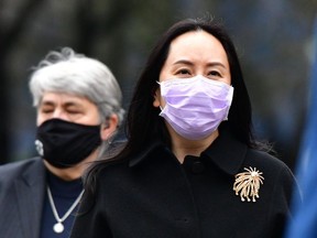 Huawei Chief Financial Officer, Meng Wanzhou, arrives at British Columbia Supreme Court, with her security team in Vancouver, British Columbia, Canada, on January 12, 2021.
