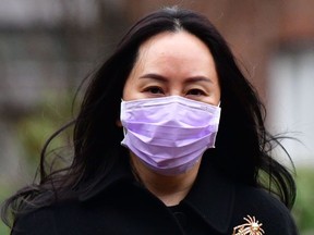 In this file photo taken on Jan. 12, 2021, Huawei Chief Financial Officer, Meng Wanzhou, leaves her Vancouver home to attend British Columbia Supreme Court, in Vancouver, Canada.