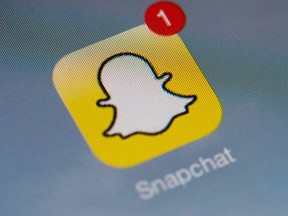 This file photo taken on January 02, 2014 shows the logo of mobile app "Snapchat" displayed on a tablet on January 2, 2014 in Paris.