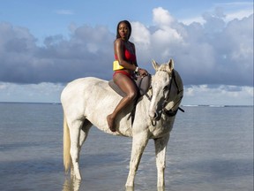 Ottawa-based style and travel influencer Dominique Baker, who is also a manager with the Public Health Agency of Canada — rides a horse in Montego Bay, Jamaica in Nov. 2020.