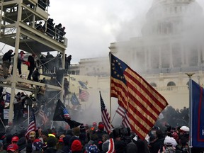Pic of flag in front of capitol: Supporters of U.S. President Donald Trump protest in front of the U.S. Capitol Building in Washington, U.S. on Jan. 6, 2021.