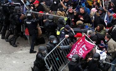 Pro-Trump protesters attempt to tear down a police barricade during a rally to contest the certification of the 2020 U.S. presidential election results by the U.S. Congress, at the U.S. Capitol Building in Washington, U.S., on Jan. 6, 2021.