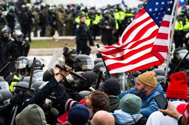 Supporters of U.S. President Donald Trump fight with riot police outside the Capitol building on Jan. 6, 2021, in Washington, DC.