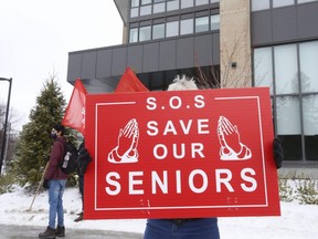People rally to protect seniors living in long-term care homes from COVID-19 in Toronto, Jan. 2, 2021.