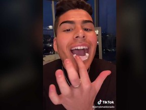 TikTok user Jerry Mal is seen in a video spreading "erection cream" on his lip.