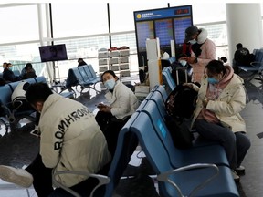 Travellers wait at Wuhan Tianhe International Airport following the coronavirus disease (COVID-19) outbreak in Wuhan, Hubei province, China January 2, 2021.
