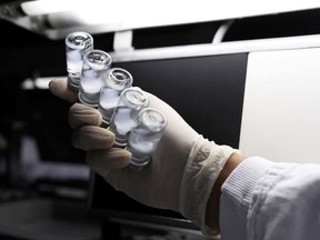 An employee inspects vials containing CoronaVac, Sinovac Biotech's vaccine against the coronavirus disease (COVID-19), at Butantan biomedical center in Sao Paulo, Brazil, January 12, 2021.