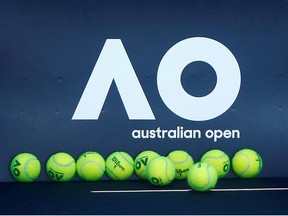 Tennis balls are pictured in front of the Australian Open logo before the tennis tournament.