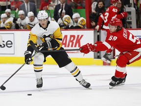 Pittsburgh Penguins defenceman John Marino (6) attacks with the puck as Detroit Red Wings left wing Tyler Bertuzzi (59) defends Friday, Jan. 17, 2020, in Detroit.