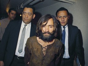 Got him. LAPD homicide detectives escort cult leader Charles Manson.