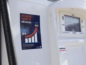 A gas pump displays an anti-carbon tax sticker in Toronto on Thursday, August 29, 2019.