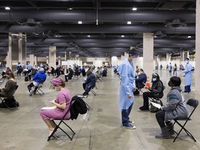 People wait in an observation area after receiving a coronavirus vaccine at the mass-vaccination site set up by Philly Fighting COVID at the Pennsylvania Convention Center on Jan. 15.