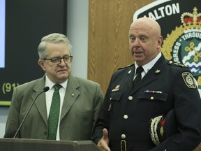 Police Services Board Chair and Oakville Mayor Rob Burton, left, stands with Halton Police Chief Stephen Tanner at a press conference in Oct. 2019.