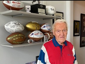 Marv Levy, 95, poses in his Chicago condo in August with some of his keepsakes from 47 years of coaching football.